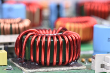 Copper coil, inductor on circuit board with blurred background
