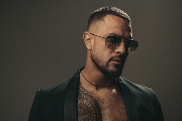 Mans fashions, stylish male model. Closeup man portrait. Man face. Handsome bearded man - face half...