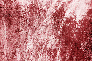 Сraked weathered cement wall texture in red tone.