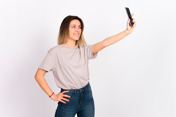 Girl on white with cell phone smiling using  internet social media concept 