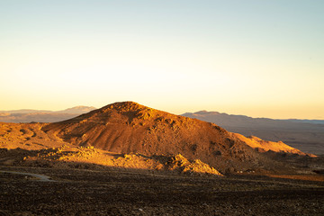 golden morning light on red earth hill, mountains, Eastern Sierra Nevada, California, USA