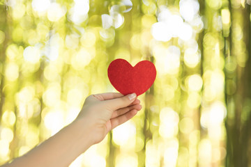 Woman hands holding red heart