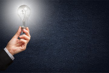 Businessman holding light bulb. idea, solution concept