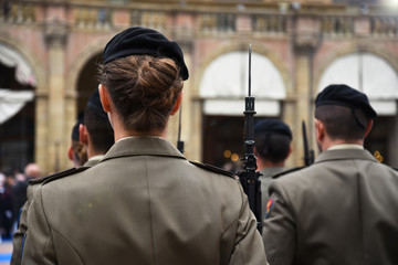 Detail with uniformed women standing during the military ceremony in Bologna, Italy. In the...