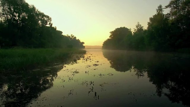 aerial view of river at sunrise 4K, fly over morning mist on the river, Very high view of the river at sunrise, Aerial view of mystical river at sunrise with fog, sun above the river aerial