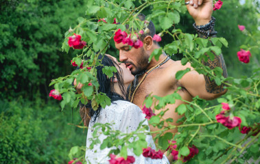 Spring lovers in blooming garden. Lovely spring couple kiss and hugs. Summer couple and erotic moment. Couple outdoors in blooming trees. Beauty lovers in flowers.