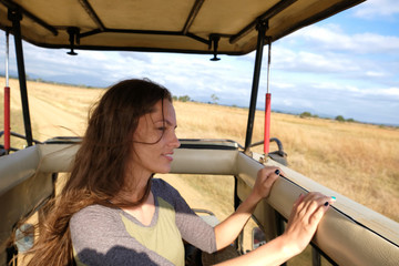 Young woman discover african nature by car Tanzania safari