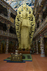 Buddha statue in Linh Phuoc Pagoda on background in mosaic style from shards of porcelain and glass