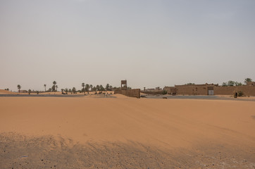 Fototapeta na wymiar Merzouga village near sahara Erg Chebbi dune in sand storm. Morocco
