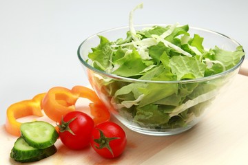 Lettuce, cucumber, bell pepper and tomatoes making up a salad