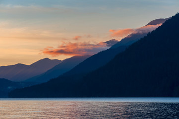Dramatic Red Sunset on the Olympic Mountains at Lake Crescent, Washington. The view from a pier at Lake Crescent Lodge on the Olympic Peninsula during a glorious sunset.