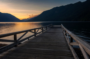 Sunset at Lake Crescent Lodge on the Olympic Peninsula. A boat dock juts out over Lake Crescent during a glorious sunset on a calm autumnal evening.
