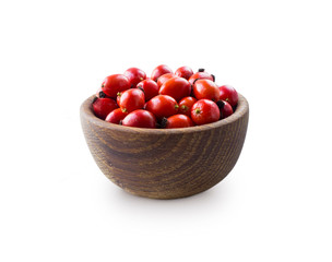 Fresh rosehip berries on white background. Top view. Rosehip berries in a bowl isolated on white background. Rose hip berries with copy space for text.