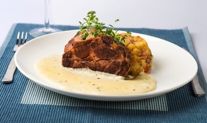 Pork tenderloin with pepper sauce and mashed potato,closeup.