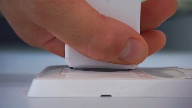 Man sticks and takes out the adapter plug and sockets. 1920X1080 Full Hd.	