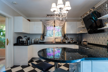 The dining room in classical style, light furniture, marble, luxury.