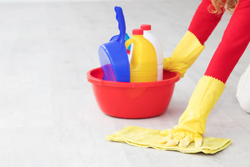 hand with cleaning products scrubbing the floor