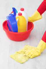 hand with cleaning products scrubbing the floor
