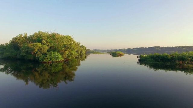 aerial view of river at sunrise 4K, forest and river in morning mist,  Flying over the river green trees at sunrise, Very high view of the river forest at sunrise