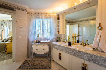 The dining room in classical style, light furniture, marble, luxury.