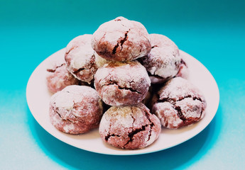 Chocolate crackle cookies on blue background. copy space