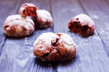 Chocolate crackle cookies on dark wooden background