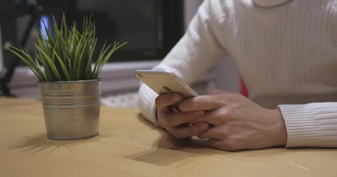 Young Adult at a Desk Texting