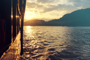 Sunset cruise on the Mekong River in Luang Prabang, Laos, seen from the traditional boat