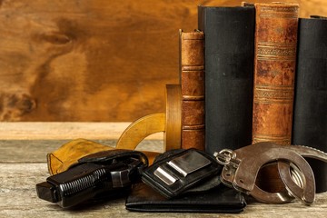 Police desk. Books of laws and police handcuffs. Investigation of crime. Gun and laws. Law and Order.