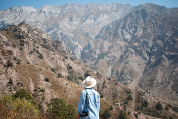 Photographer tourist with camera while standing on the mountain