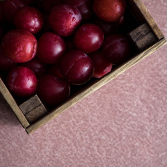 Wooden box with plums