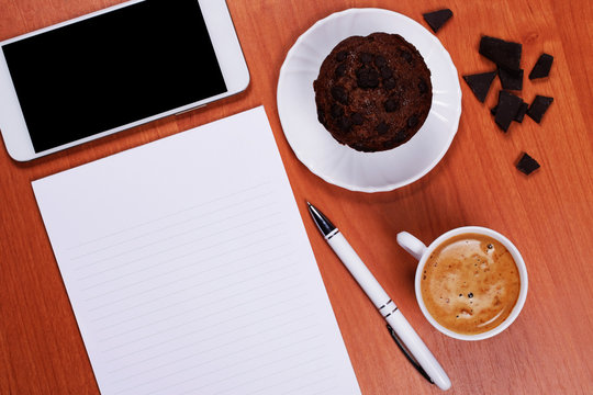 Coffee and muffin at the working place.