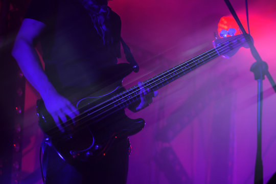 Electric bass guitar player on a stage
