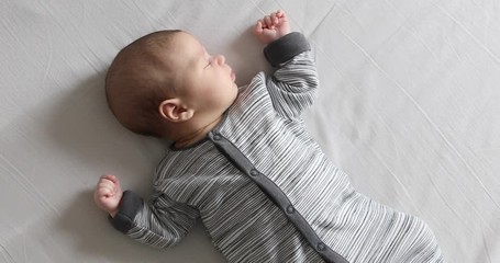 Peaceful adorable baby sleeping on his bed in a room. Soft focus. Sleeping baby concept. One month babyboy sleeps at home - Powered by Adobe