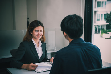 Bussiness woman and man talking about new product,Representatives from the insurance companies selling products to customers,Thailand people