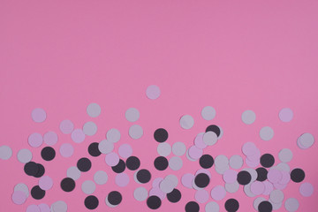Pink background with confetti.