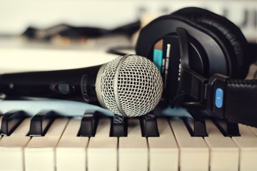 microphone and headphones on piano