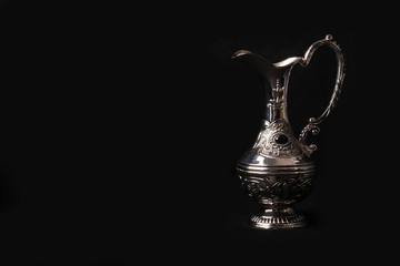Fototapeta na wymiar silver jug of the Eastern black background