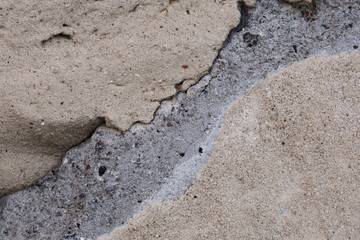 A fragment of a wall of concrete blocks, along which cracks went.