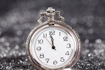 Fototapeta na wymiar Old silver watch closeup at midnight