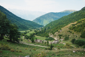 Georgian landscape with mountains, greenery and ancient ruins 