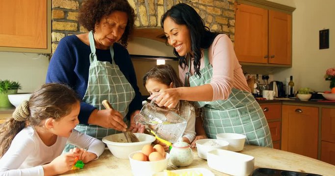 Siblings preparing food with family in kitchen 4k