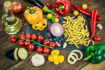  food cooking ingredients on dark background with , top view, Vegetables pasta and spices