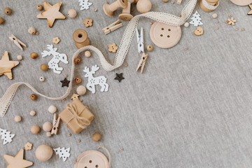 Craft and wooden Christmas flatlay on farbic background.