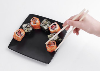 closeup.sticks and a set of Sushi rolls