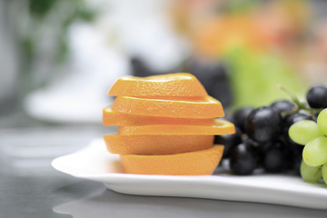 close up.plates with grapes and fruits on blurred background