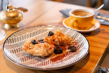 Napoleon dessert with salted caramel and prunes, in the original serving. Breakfast, pleasant morning, the beginning of the working day