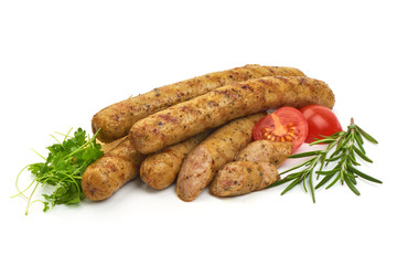 Grilled German Thin Sausages with herbs, pepper and tomatoes, isolated on a white background. Close-up