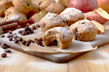 Traditional German Christmas pastry mini stollen on parchment paper on plank wood table