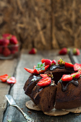 Traditional chocolate gugelhupf with strawberry. Brownie cake. Chocolate kex. German baked goods. Australian cake. National bakery. Rustic cake. Round cake with berries.